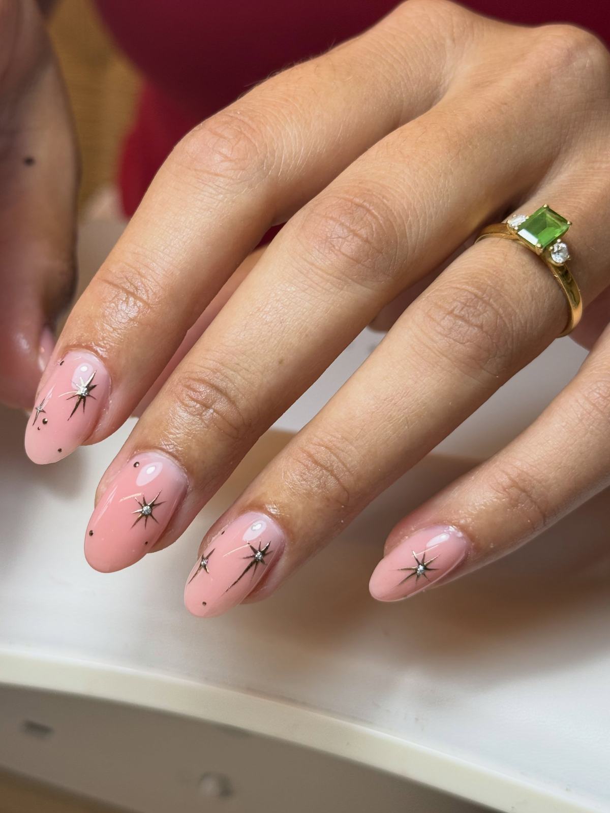 Pink almond nails with fine black and silver starburst art